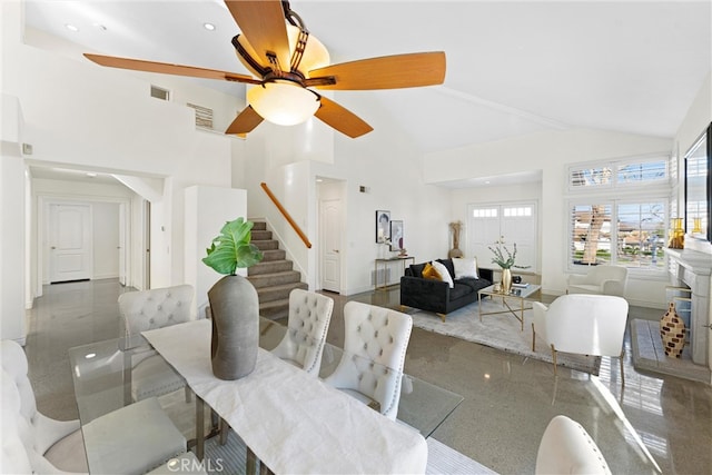 dining room with stairway, ceiling fan, visible vents, and high vaulted ceiling