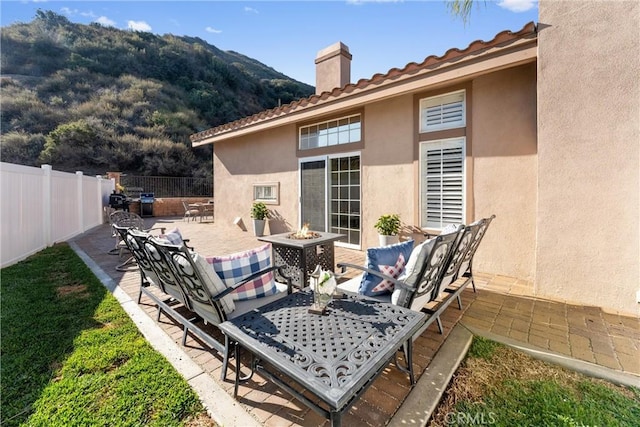 view of patio / terrace featuring outdoor dining space, a fire pit, and fence private yard