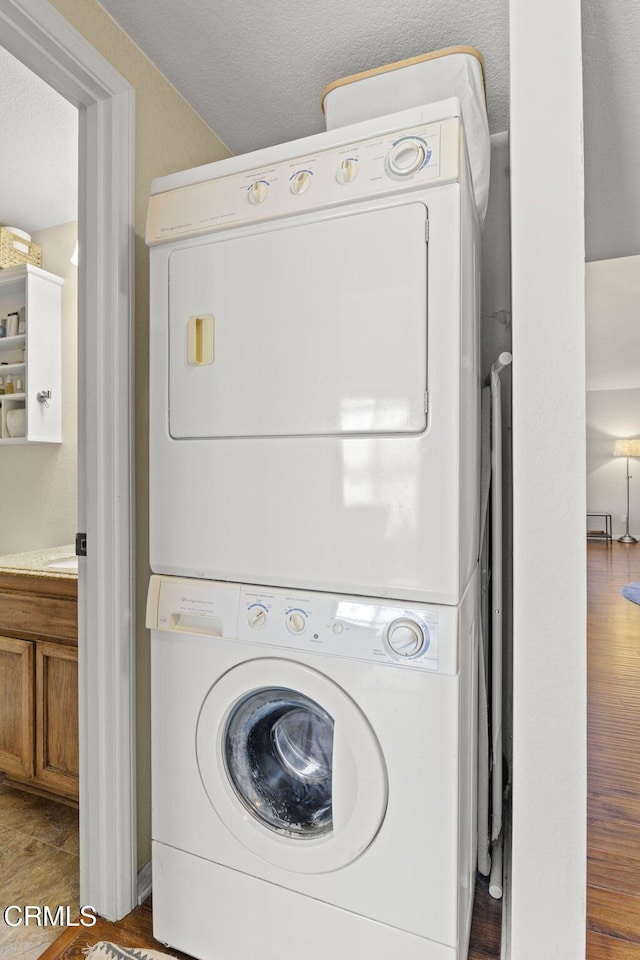 laundry area featuring laundry area and stacked washer and clothes dryer