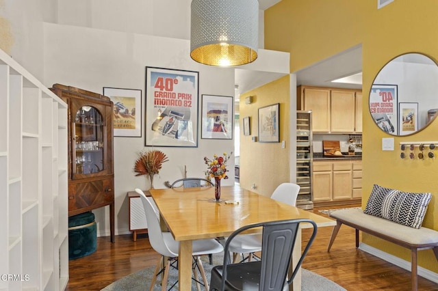 dining area featuring dark wood-type flooring and baseboards