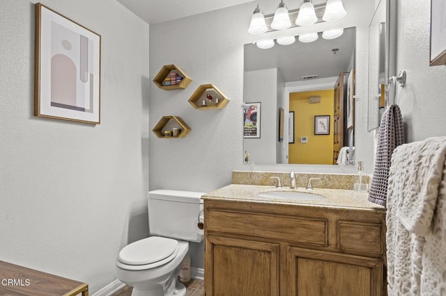 bathroom featuring visible vents, vanity, and toilet