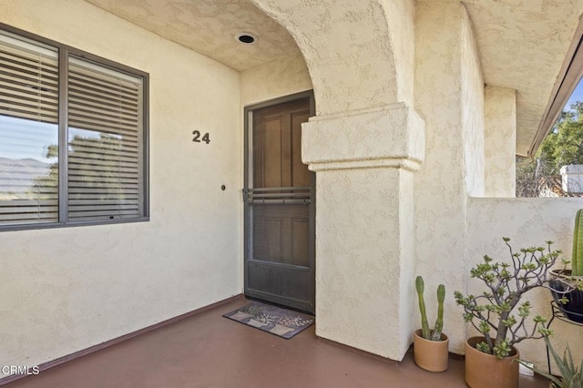 property entrance with stucco siding