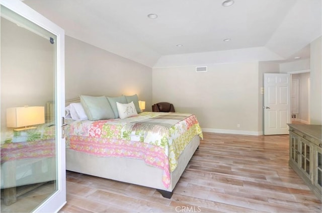 bedroom with lofted ceiling, light wood-style flooring, recessed lighting, visible vents, and baseboards