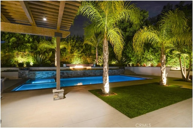 view of pool featuring an outdoor fire pit, a lawn, and a fenced in pool