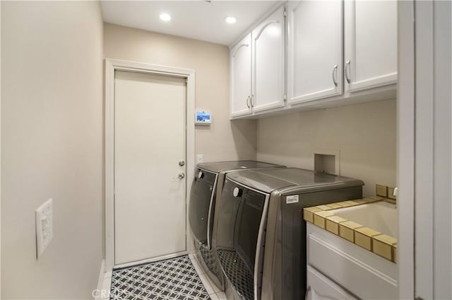 washroom featuring cabinet space, light tile patterned floors, washer and dryer, a sink, and recessed lighting