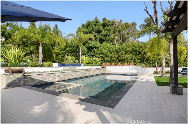 outdoor pool with a patio area