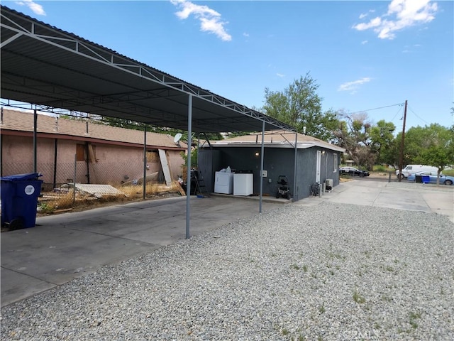 view of vehicle parking featuring washing machine and clothes dryer