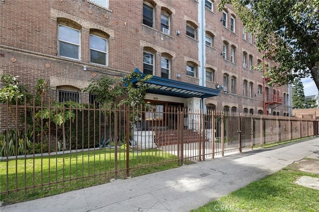 view of building exterior featuring a fenced front yard