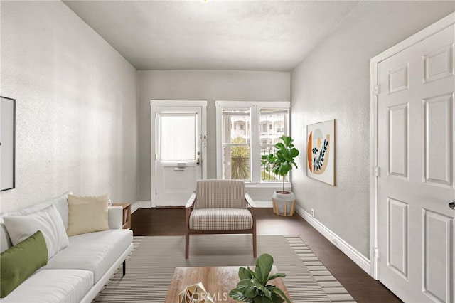 living area with dark wood-style floors and baseboards