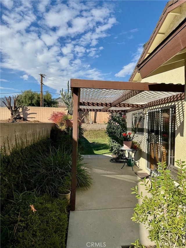 view of patio / terrace with a pergola and fence