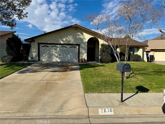 ranch-style home with stucco siding, an attached garage, concrete driveway, and a front yard