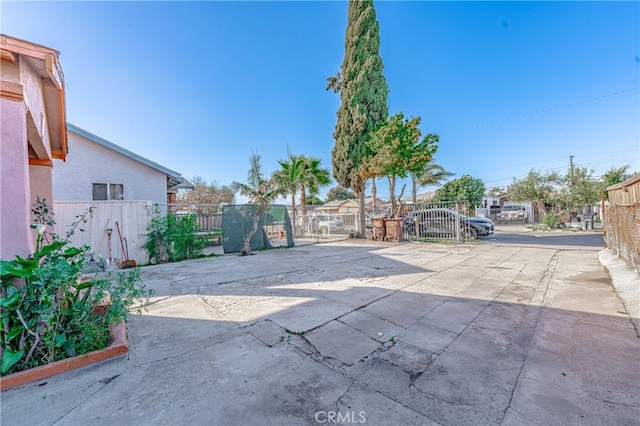 view of patio with a gate and fence