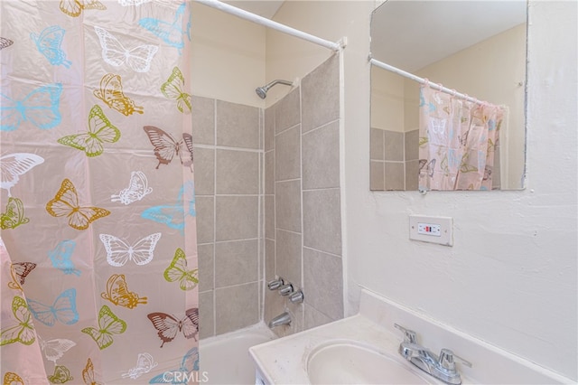 full bathroom with shower / bathtub combination with curtain and a sink