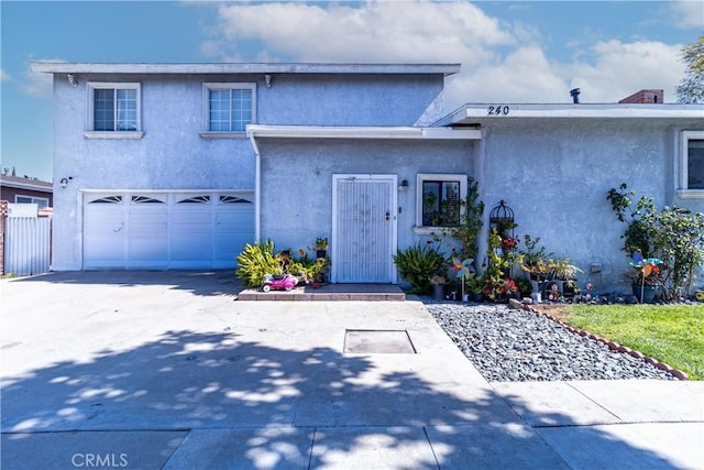 view of front of home featuring stucco siding, driveway, and a garage