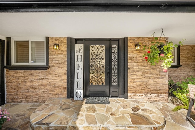 property entrance featuring stone siding