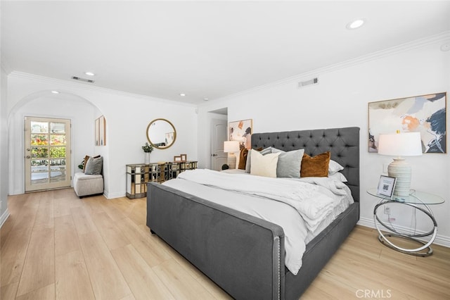 bedroom with arched walkways, visible vents, baseboards, access to outside, and light wood finished floors