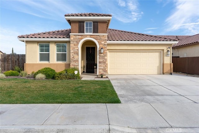 mediterranean / spanish house featuring an attached garage, fence, driveway, stucco siding, and a front lawn