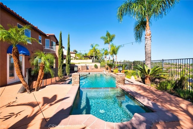 view of swimming pool featuring a fenced backyard and a pool with connected hot tub