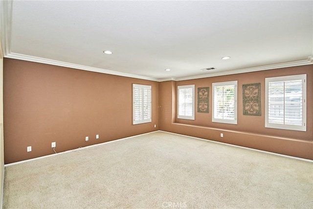 empty room with ornamental molding, carpet flooring, visible vents, and recessed lighting