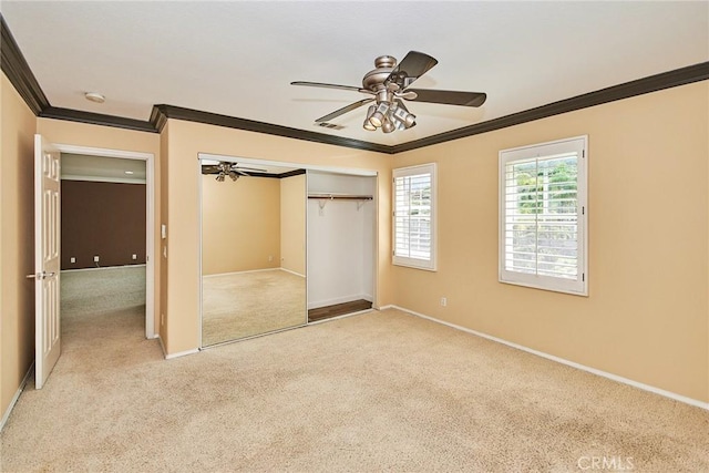 unfurnished bedroom featuring ceiling fan, light carpet, baseboards, ornamental molding, and a closet