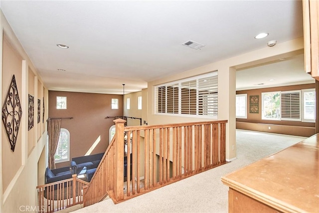 corridor with visible vents, carpet flooring, an upstairs landing, and recessed lighting