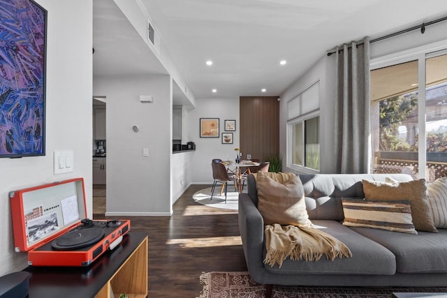 living room featuring baseboards, dark wood-style flooring, and recessed lighting