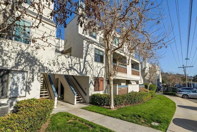 view of property with central AC and stairway