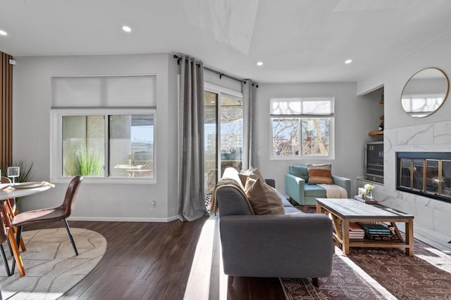 living room with a fireplace, baseboards, dark wood finished floors, and recessed lighting