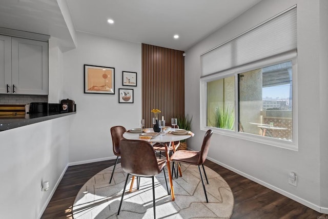 dining area with baseboards, dark wood finished floors, and recessed lighting