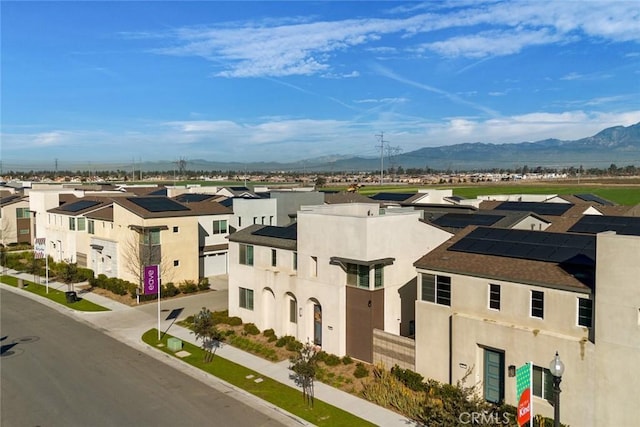 drone / aerial view with a residential view and a mountain view