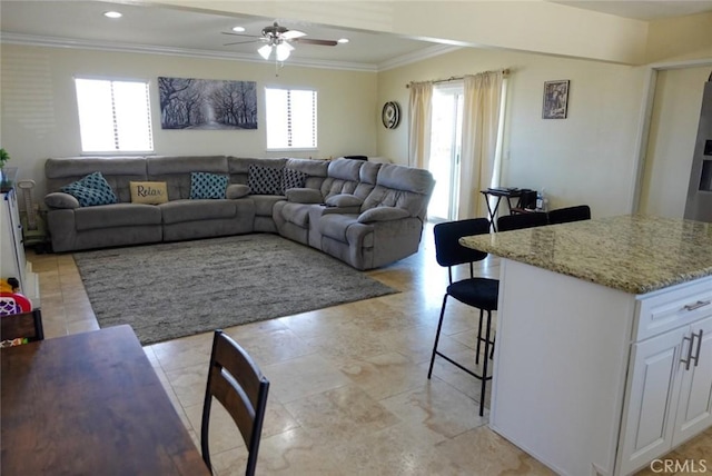 living area featuring crown molding, a ceiling fan, and recessed lighting