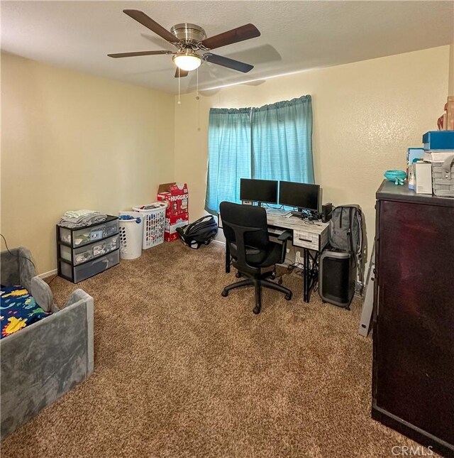 office with a ceiling fan and carpet