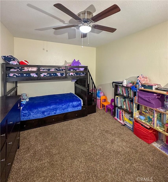 bedroom featuring carpet flooring, a ceiling fan, and a textured ceiling