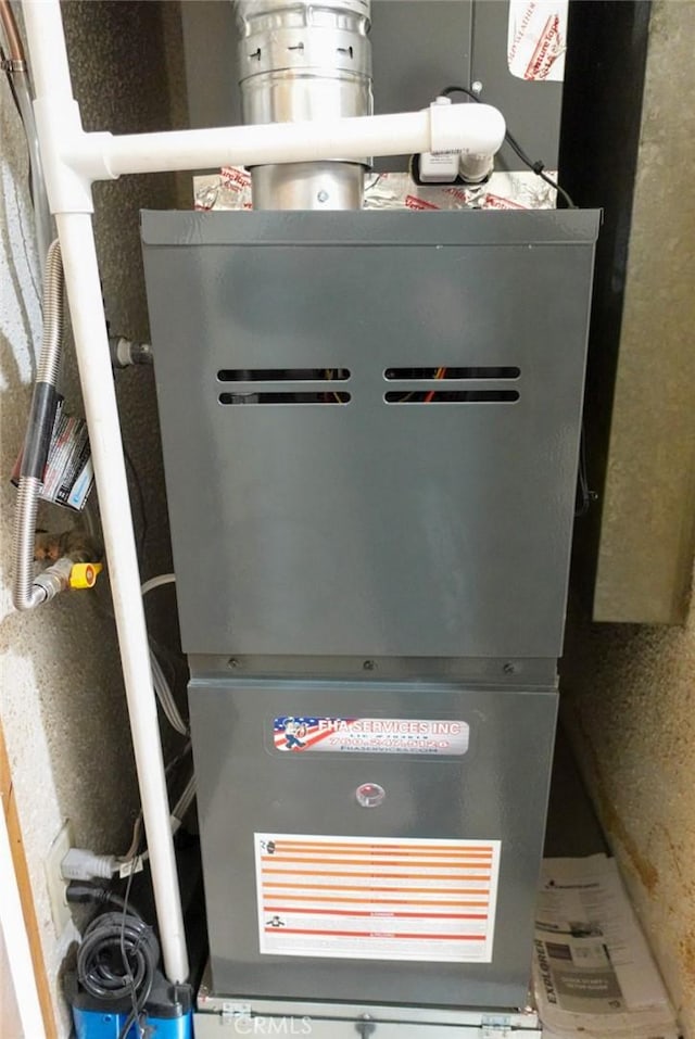 utility room featuring heating unit