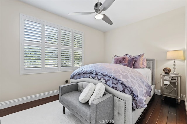 bedroom with a ceiling fan, dark wood-style flooring, and baseboards