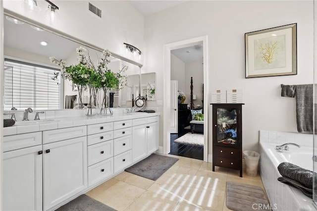 bathroom featuring double vanity, visible vents, connected bathroom, tile patterned flooring, and a sink