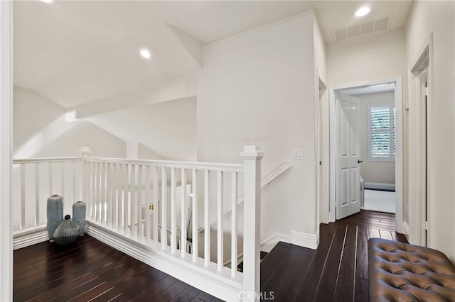 hall featuring baseboards, wood finished floors, visible vents, and recessed lighting