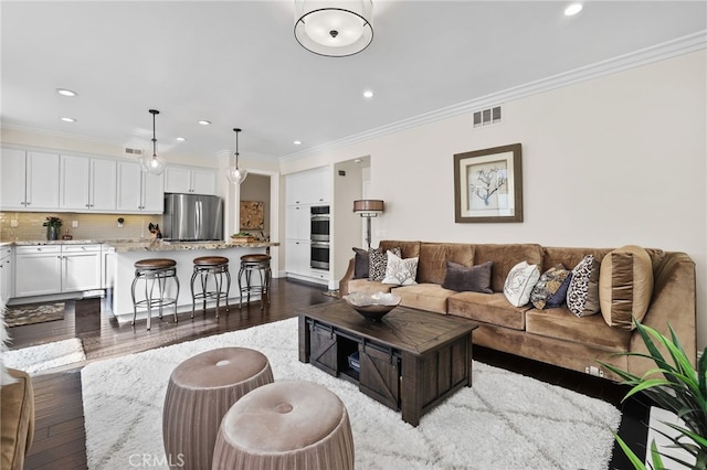 living room featuring visible vents, dark wood-type flooring, crown molding, and recessed lighting