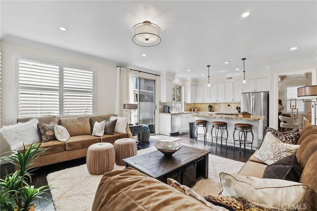 living room with recessed lighting, crown molding, and wood finished floors