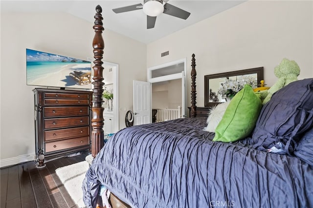 bedroom with dark wood-style flooring, visible vents, a ceiling fan, vaulted ceiling, and baseboards