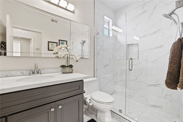 full bath with toilet, a marble finish shower, vanity, and visible vents