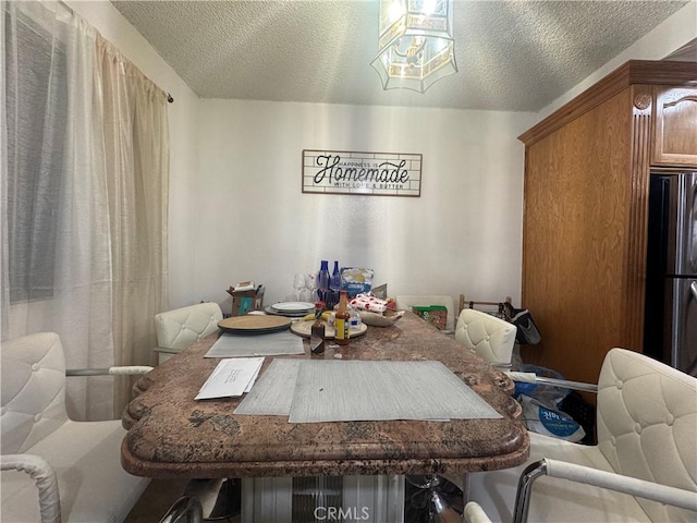 dining area featuring a textured ceiling