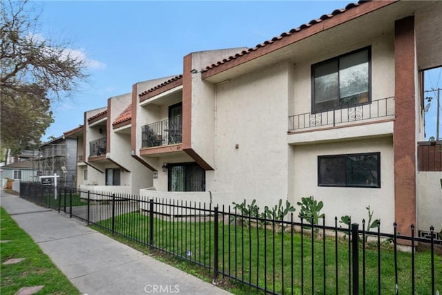 view of building exterior featuring a fenced front yard