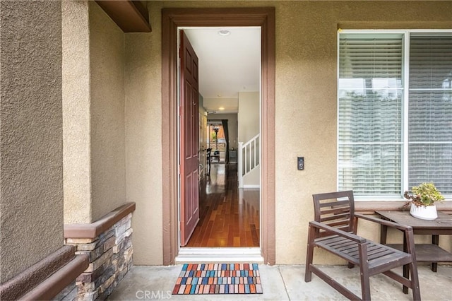 view of exterior entry featuring stucco siding