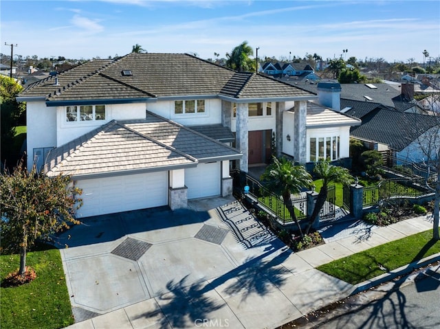 view of front facade featuring stucco siding, an attached garage, fence, a residential view, and driveway