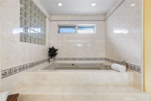 bathroom with a bath and tile walls