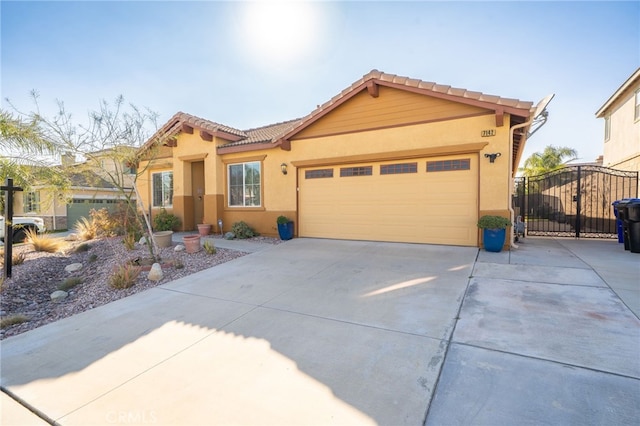 view of front of property featuring driveway, an attached garage, and stucco siding