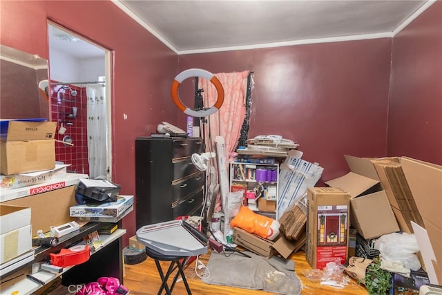 miscellaneous room with ornamental molding and wood finished floors