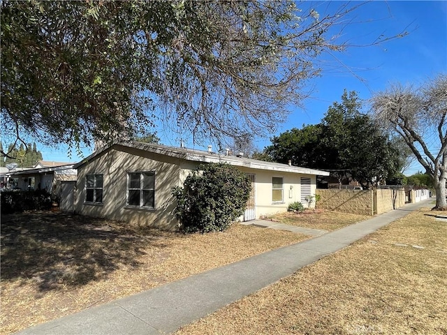 view of side of home featuring fence