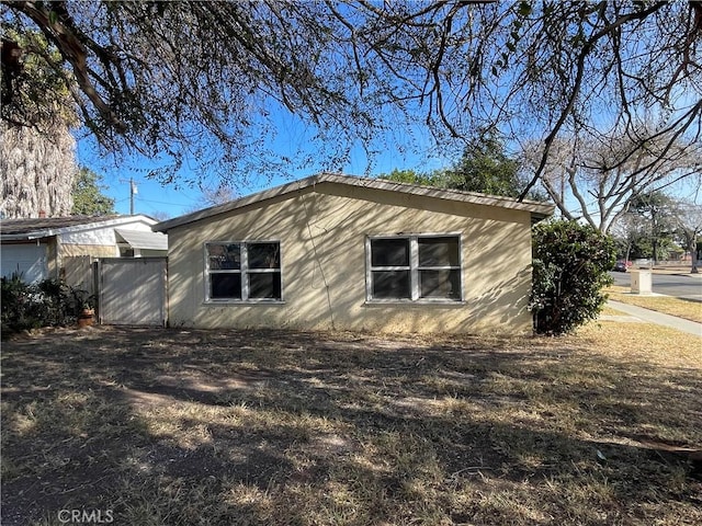 view of side of property with fence